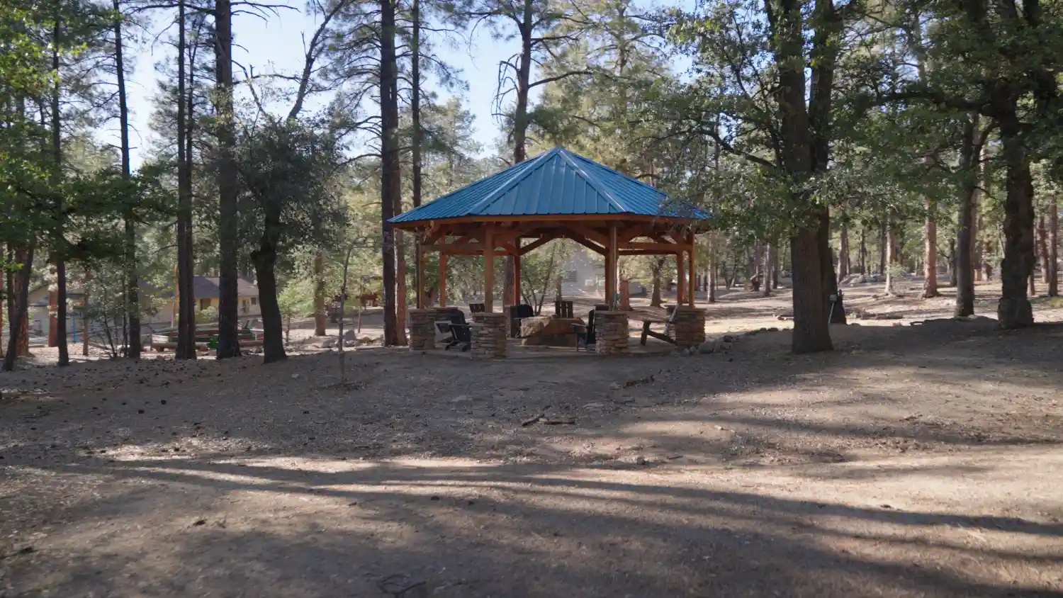 Student Housing in Prescott with Outdoor Gathering Space Outdoor covered gazebo with seating area surrounded by pine trees at student housing community in Prescott, Arizona